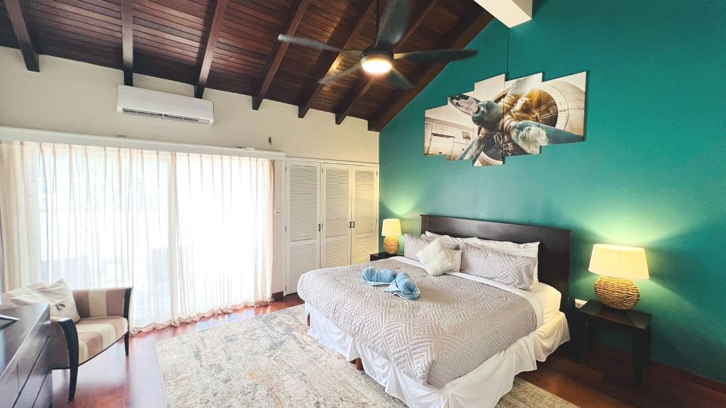 Master bedroom with wood ceiling and teal accent wall