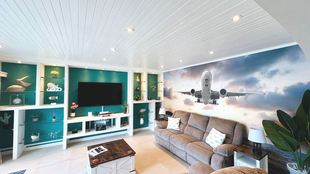 Lounge with sofa and full-wall aviation mural