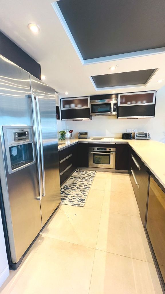 Kitchen with stainless appliances and stone counters